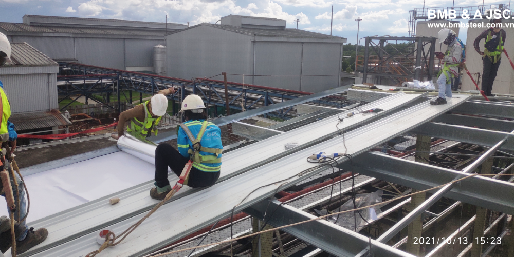 Working on the roof system of pre-engineered steel building