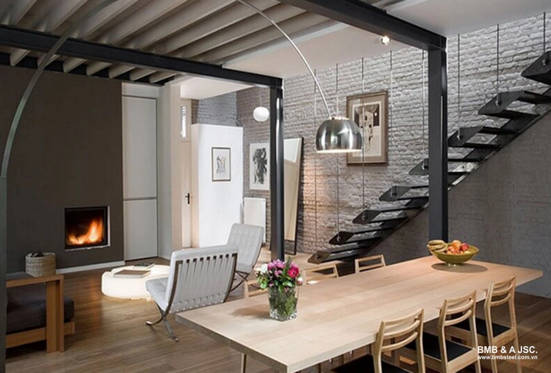 A mezzanine prefabricated house uses a steel frame as its primary structural material.